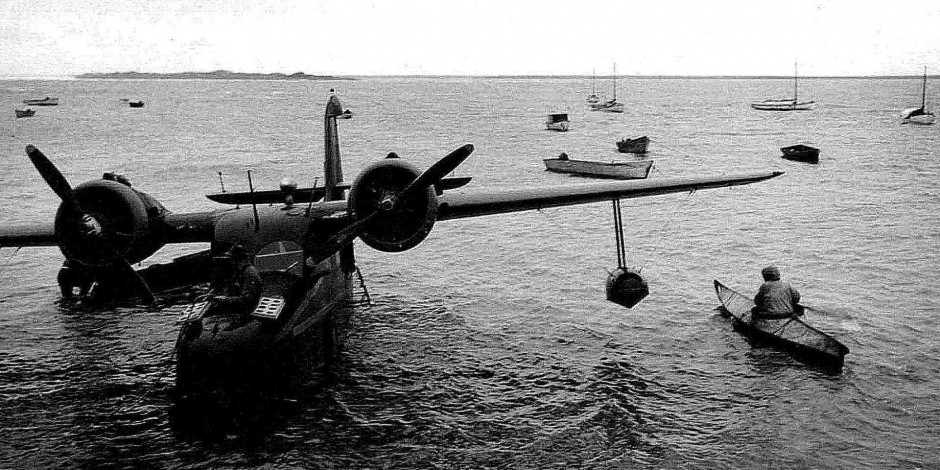 bow-of-plane-and-eskimos-in-kayaks-vintage-old-photo