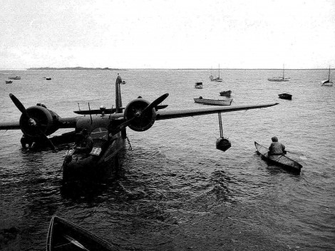 Bow-of-plane-and-eskimos-in-kayaks-vintage-old-photo